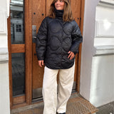 Modelfoto af pige i sort Stella jakke og beigefarvede Arianna jeans. Alt er fra BySofieSønderby