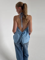 Modelfoto af pige som bærer en Daisy top i blå, samt et par Nanna jeans. Alt fra By Sofie Sønderby