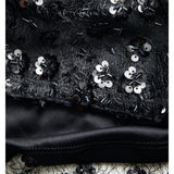 Detaljebillede af sort DREAM top med pailetter. Fra BySofieSønderby