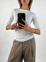 Stemningsbillede af pige der bærer en hvid FIFI boatneck bluse, samt beige MONI bukser.  Fra BySofieSønderby