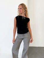 Modelfoto af pige i sort HOLLY top, samt grå NANNA jeans. Alt er fra BySofieSønderby.