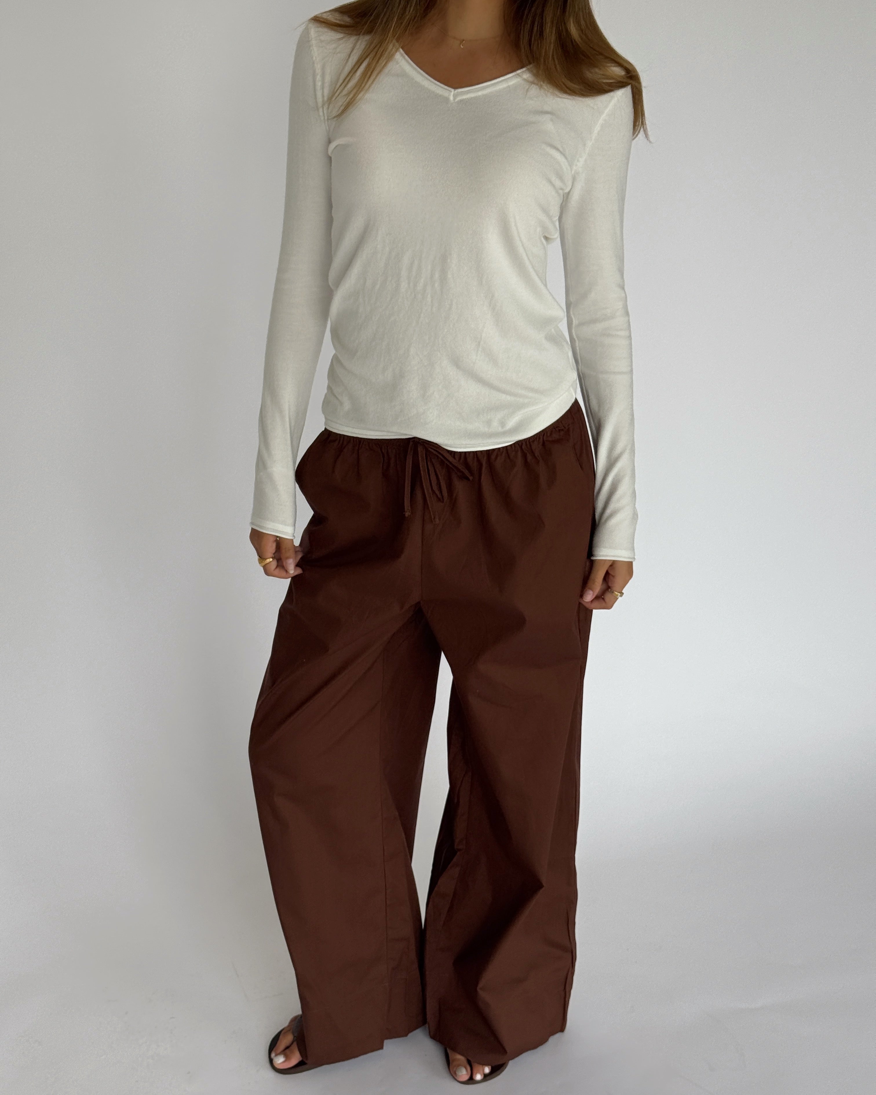 Modelbillede af LILLIE langærmet v-hals, hvid og DANIA wide leg bukser, brun. Begge fra BySofieSønderby