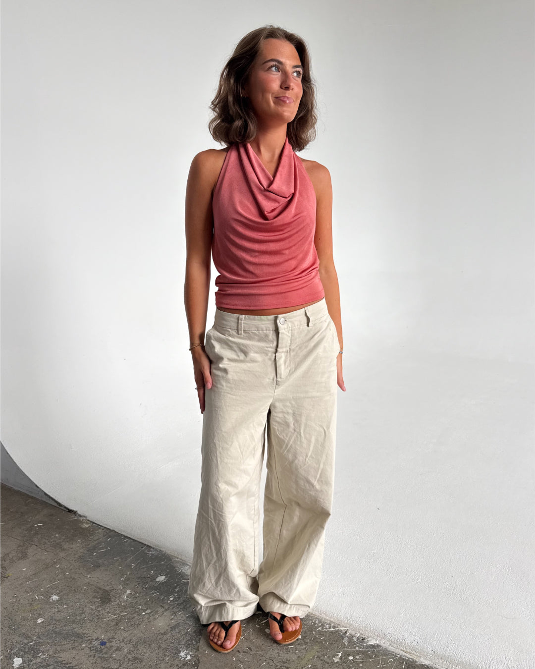 Modelfoto af pige der bærer Mavis top i Coral, samt Elanor bukser. Alt fra BySofieSønderby