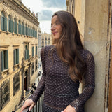 Modelfoto af pige i MINNA bluse i brun med hvide prikker, samt tilhørende nederdel.  Fra BySofieSønderby