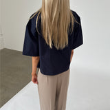 Modelfoto af pige iklædt OLEANE bluse, navy og MILAN bukser, beige - begge fra BySofieSønderby