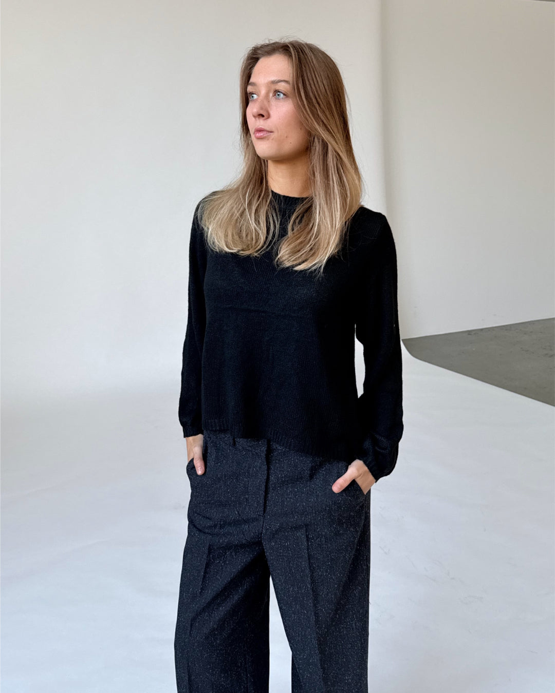 Modelfoto af pige i sort PATRICE strik, samt sortmelerede ELLIS bukser. Alt er fra BySofieSønderby.