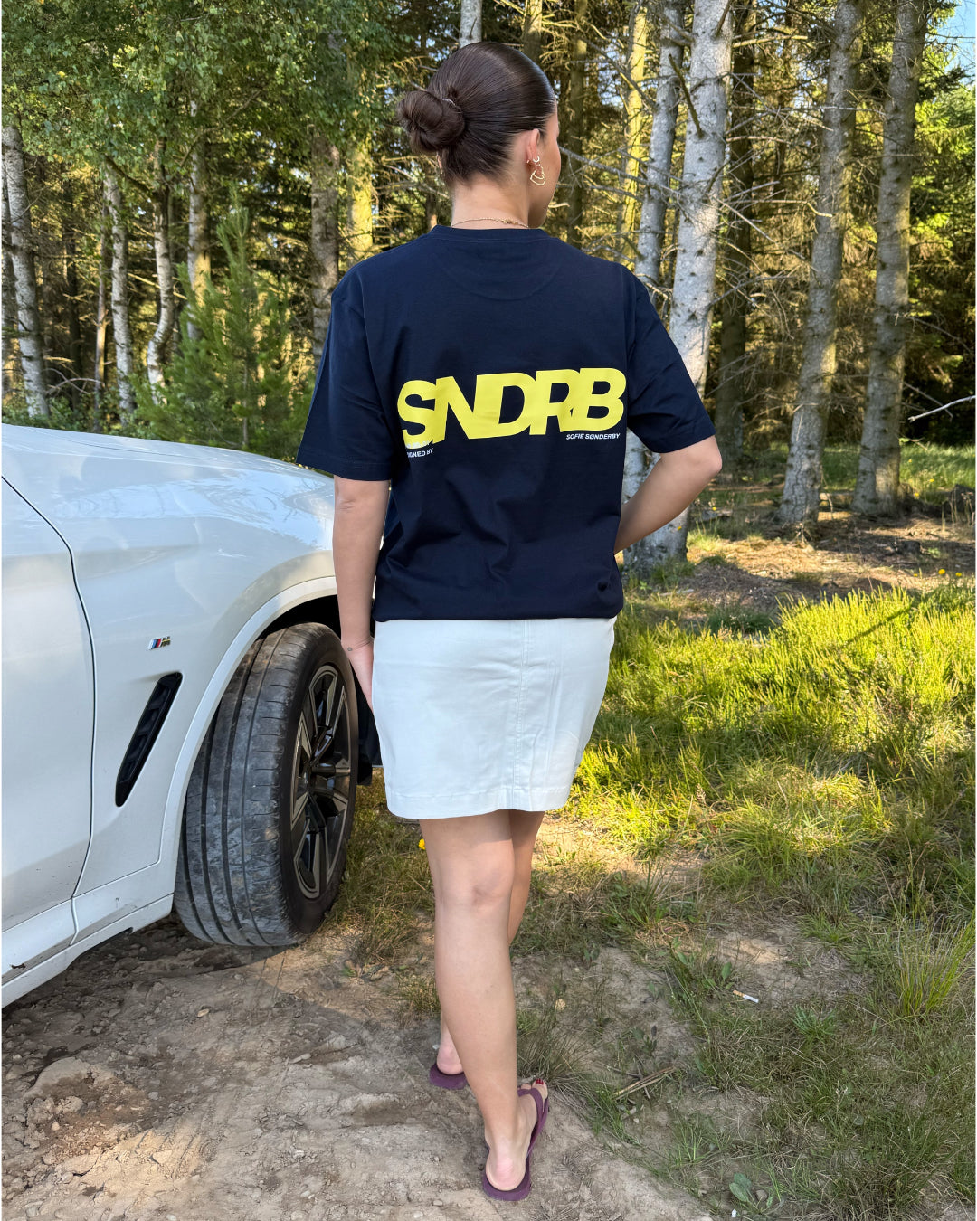 Modelfoto af pige, som bærer SNDRB t-shirt, navy og hvid nederdel - alt fra BySofieSønderby